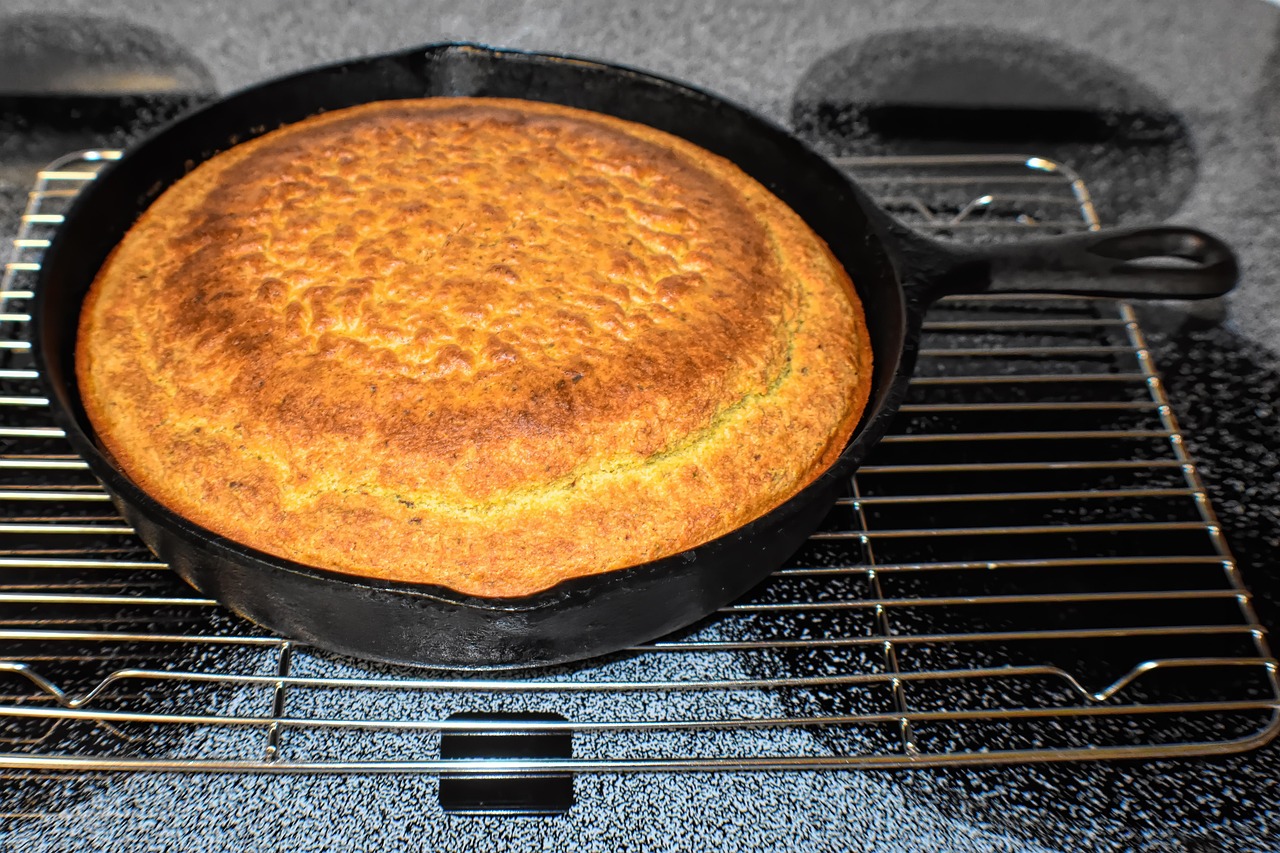 Golden homemade Southern cornbread baked in a cast iron skillet, cooling on a wire rack.